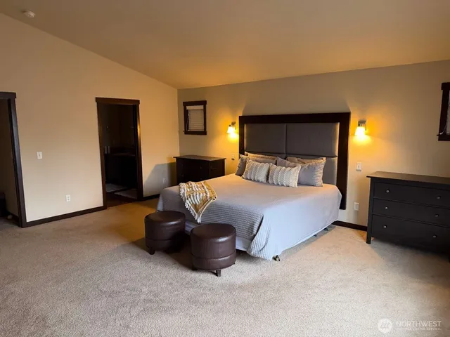 a bedroom with a bed and lamp