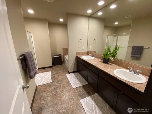 a bathroom with a double vanity sink and a mirror