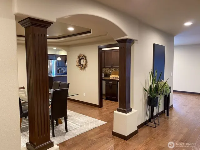 a living room with furniture and wooden floor