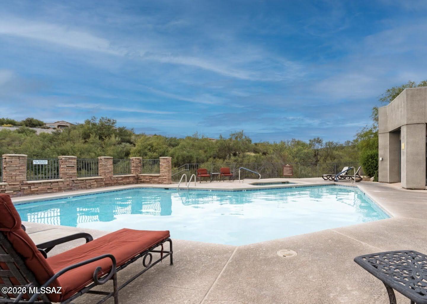 5855 North Kolb Road, Unit 11106 Tucson, AZ 85750 - Photo 34 of 36 a view of a swimming pool with a lounge chair