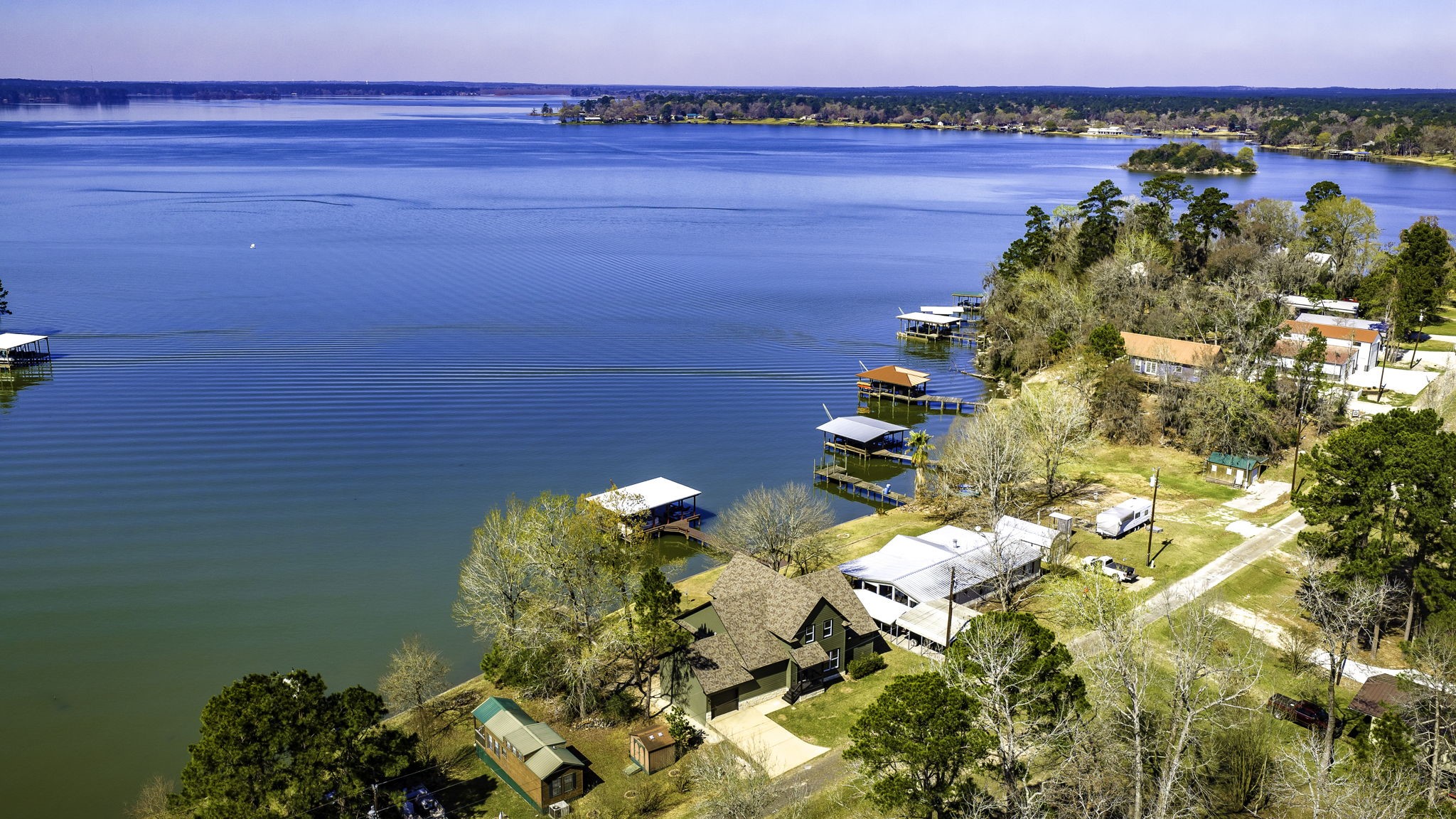 a view of a lake with table and chairs