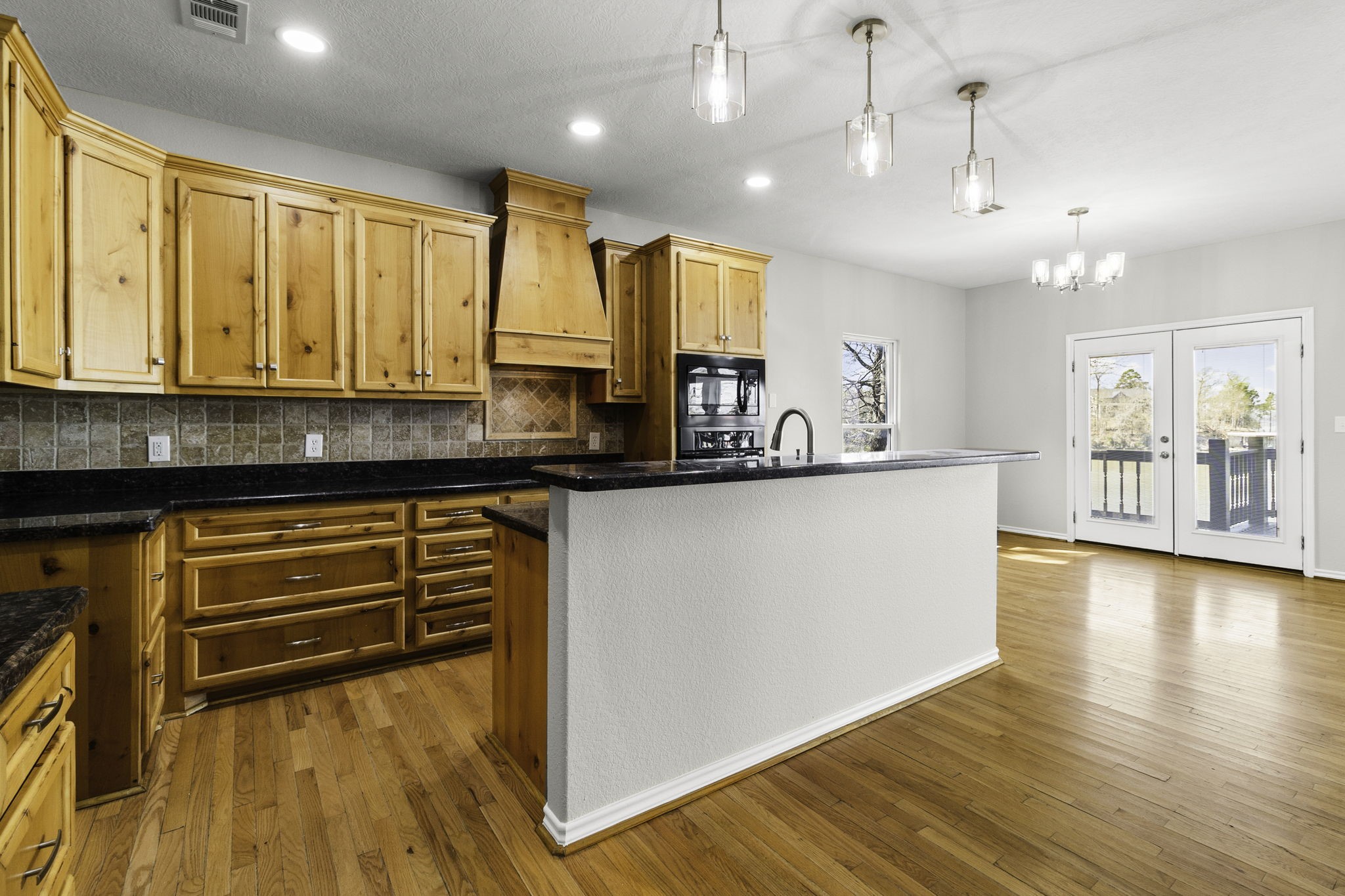 231 North Point Road Trinity, TX 75862 - Photo 11 of 50 a kitchen with stainless steel appliances granite countertop a sink a stove and a wooden floors
