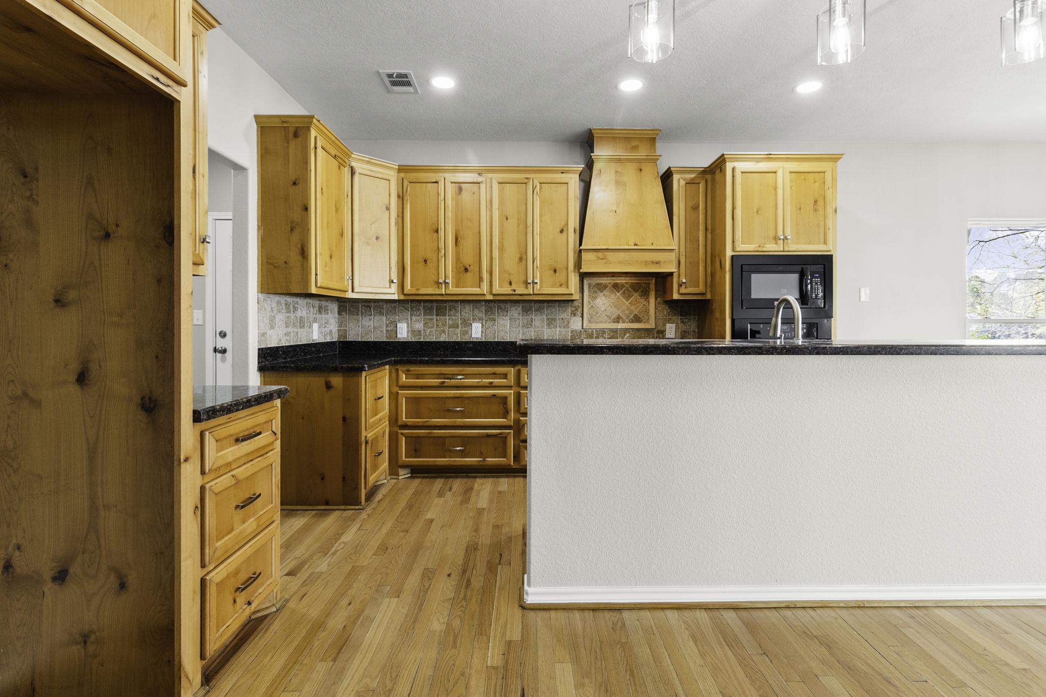 231 North Point Road Trinity, TX 75862 - Photo 12 of 50 a kitchen with stainless steel appliances granite countertop a stove a sink and a microwave