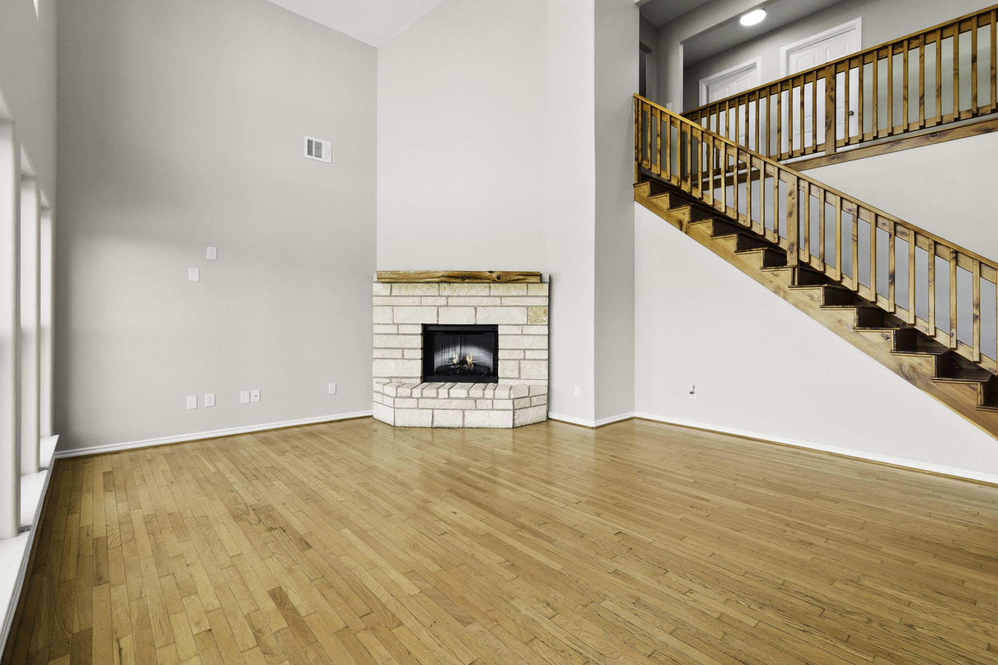 231 North Point Road Trinity, TX 75862 - Photo 23 of 50 a view of an empty room with wooden floor and a fireplace