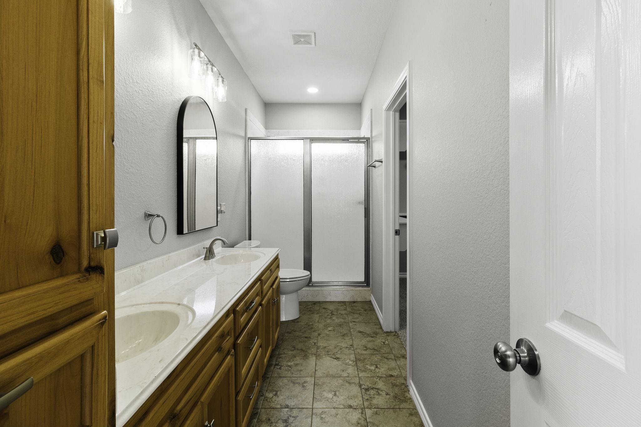 231 North Point Road Trinity, TX 75862 - Photo 28 of 50 a spacious bathroom with a double vanity sink and mirror