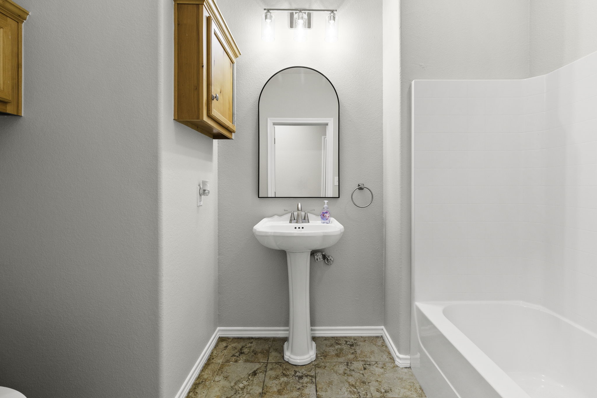 231 North Point Road Trinity, TX 75862 - Photo 33 of 50 a bathroom with a sink a mirror and a bathtub
