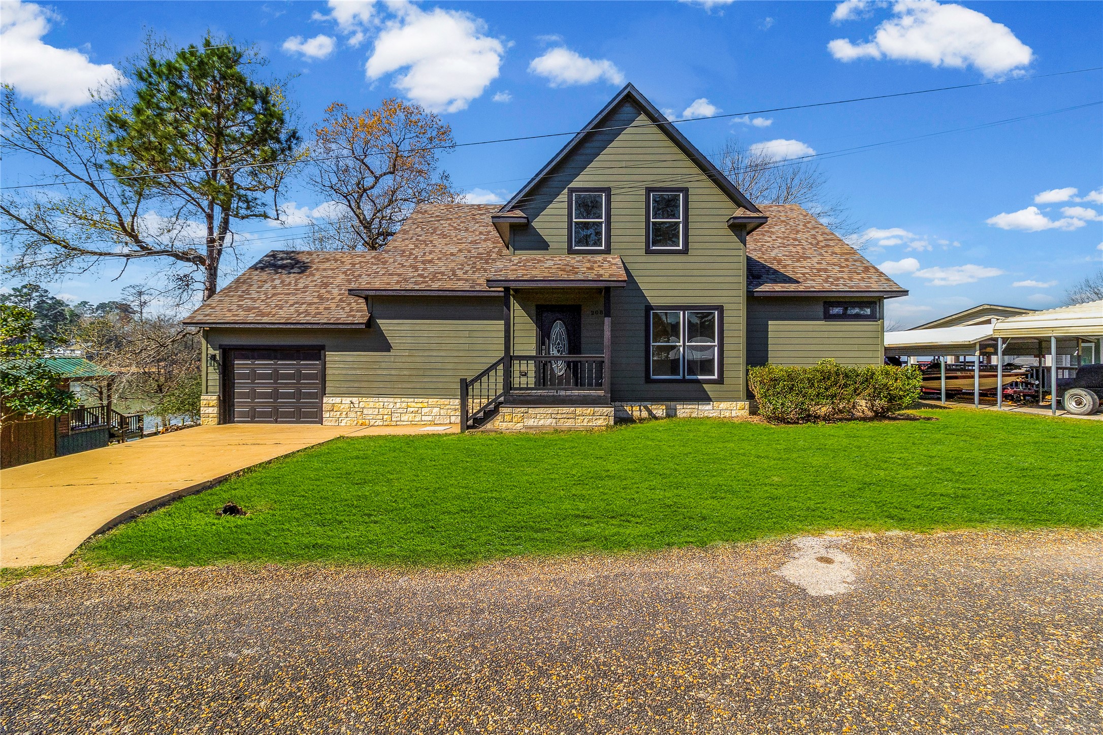 231 North Point Road Trinity, TX 75862 - Photo 6 of 50 a front view of a house with a garden and trees