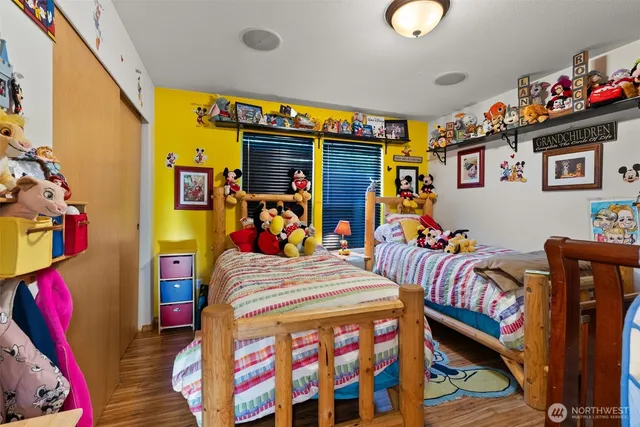 a bedroom with two beds and a baby crib