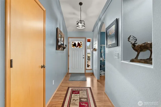 a view of a hallway with wooden floor and workspace
