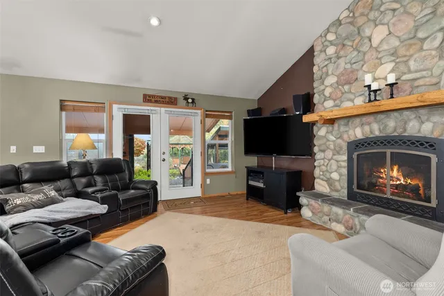 a living room with furniture a fireplace and a flat screen tv