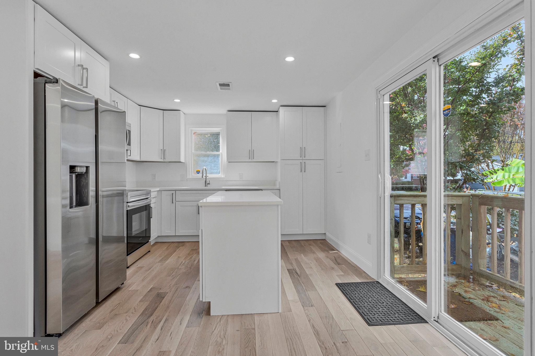 3365 Arundel On The Bay Road Annapolis, MD 21403 - Photo 14 of 48 a kitchen with white cabinets and white appliances