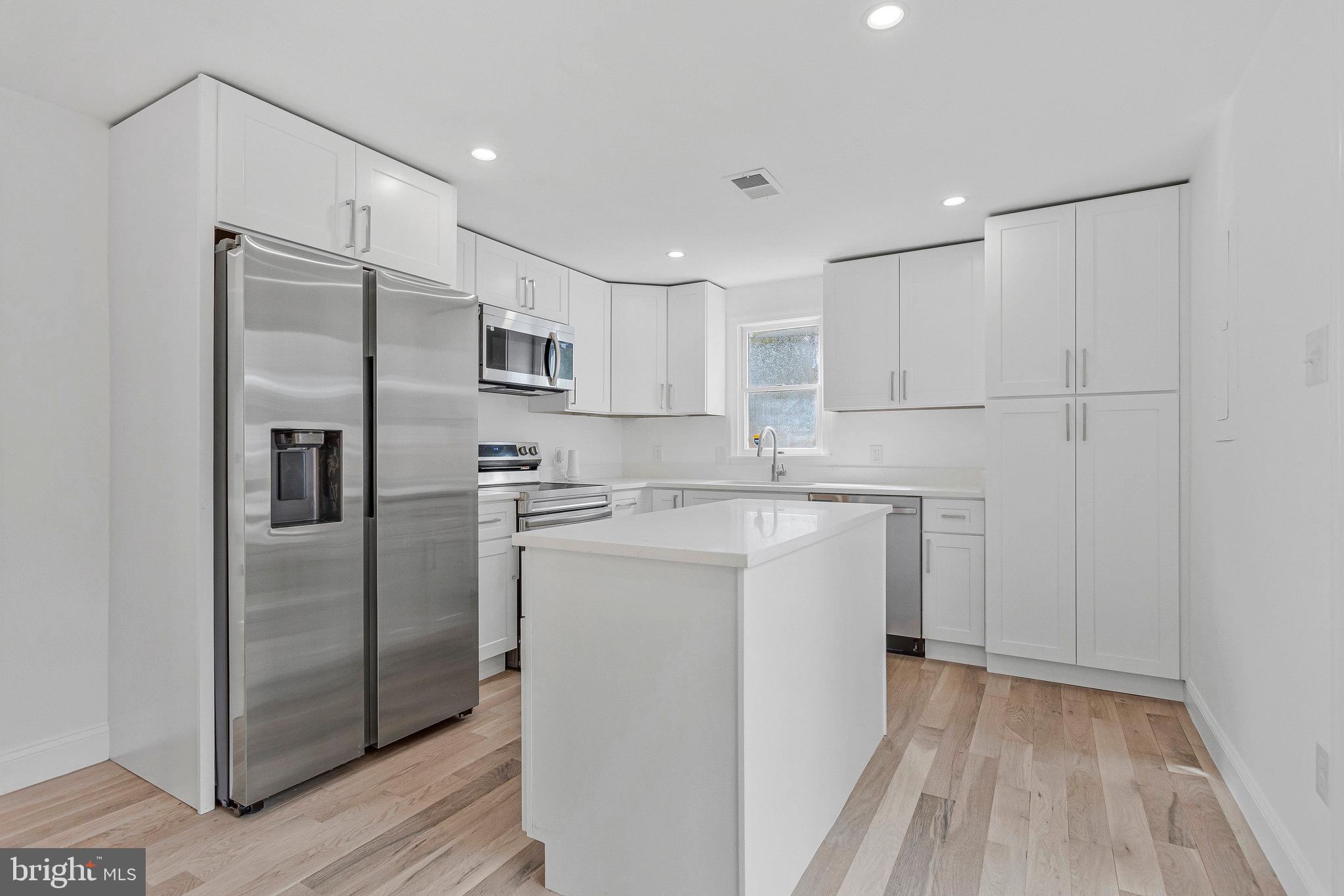 3365 Arundel On The Bay Road Annapolis, MD 21403 - Photo 15 of 48 a kitchen with a refrigerator sink and cabinets
