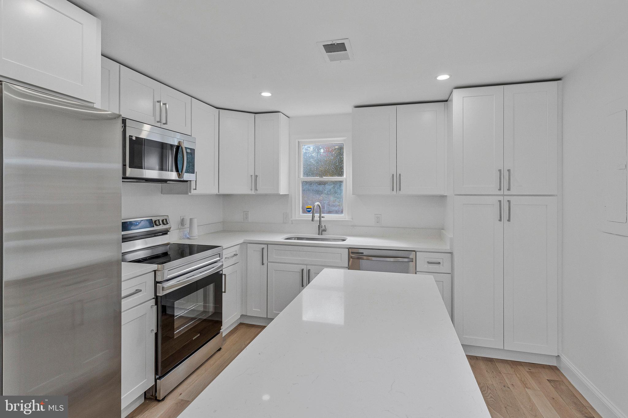 3365 Arundel On The Bay Road Annapolis, MD 21403 - Photo 16 of 48 a kitchen with stainless steel appliances granite countertop a stove a sink and a refrigerator