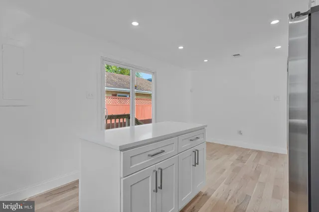 a hallway with washer dryer and wooden floor