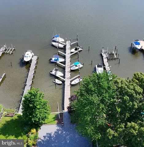 an aerial view of a house with wooden floor and a yard