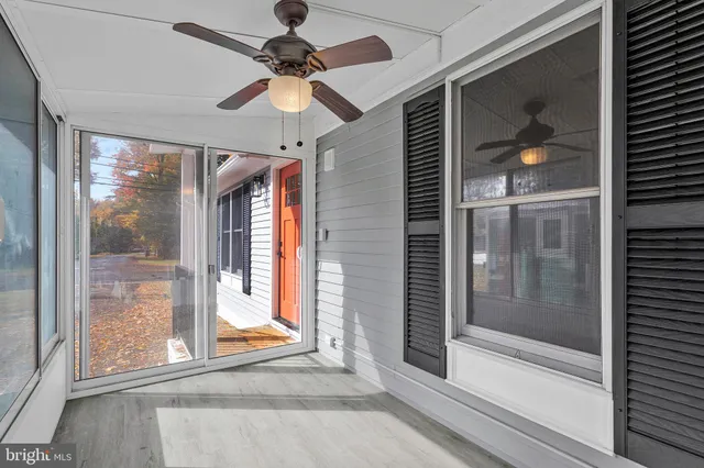 a view of a livingroom with a ceiling fan and window