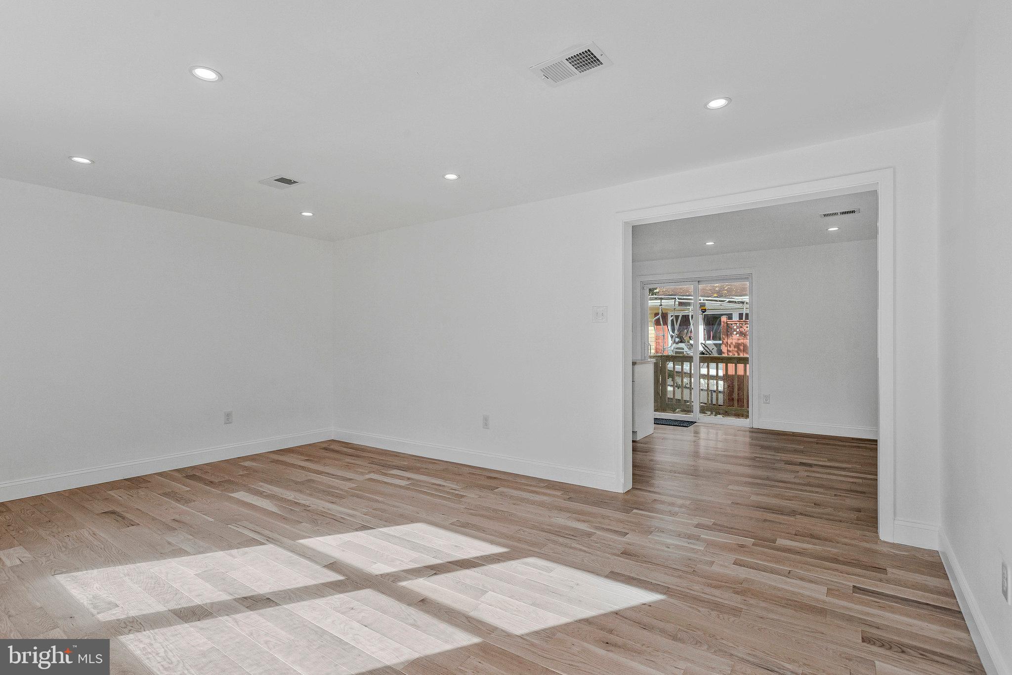 3365 Arundel On The Bay Road Annapolis, MD 21403 - Photo 8 of 48 a view of an empty room with wooden floor and a bathroom