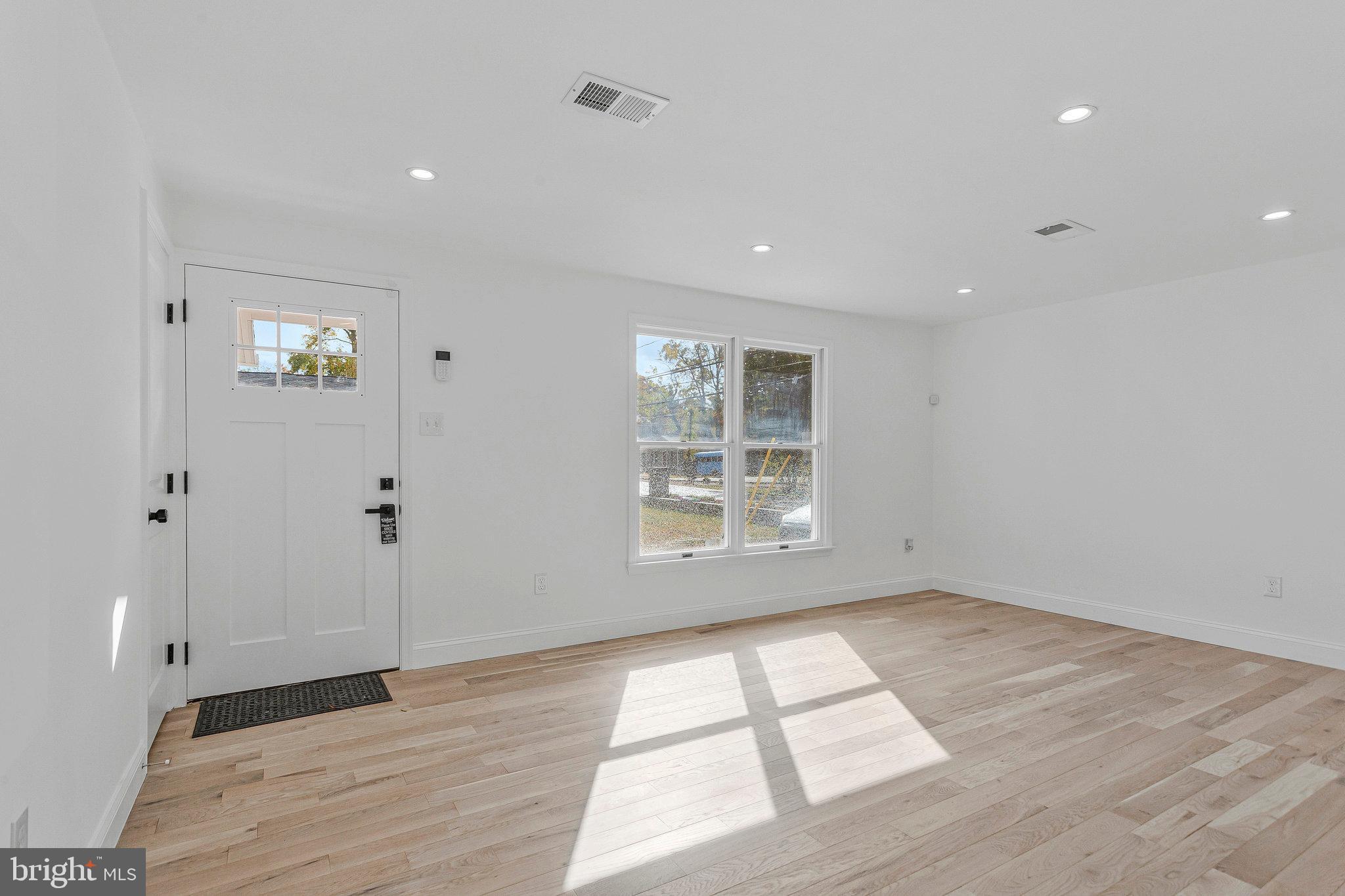 3365 Arundel On The Bay Road Annapolis, MD 21403 - Photo 10 of 48 wooden floor in an empty room with a window