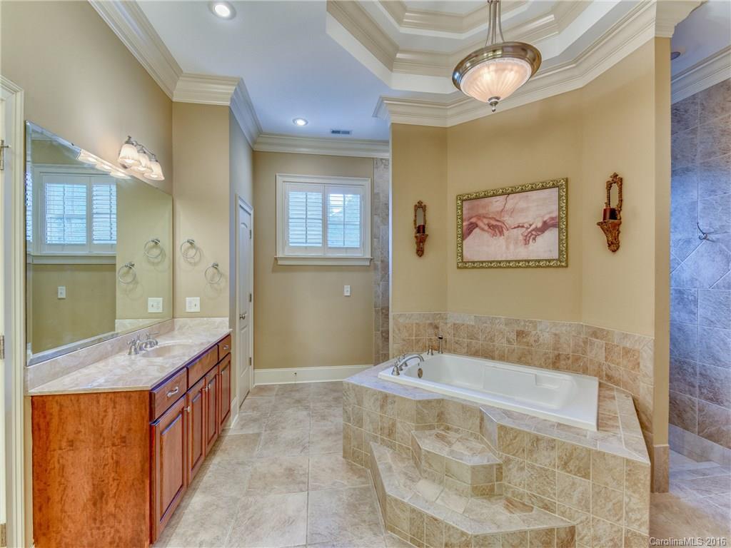 6706 Fox Ridge Circle Davidson, NC 28036 - Photo 11 of 24 a spacious bathroom with a tub sink and mirror