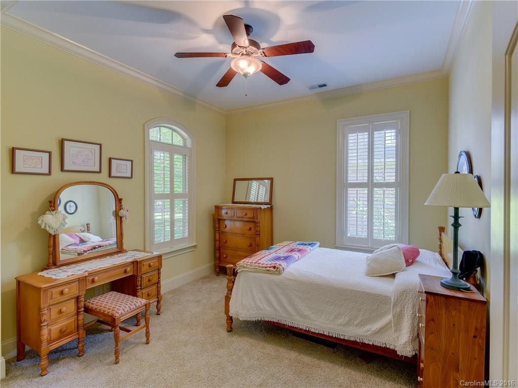 6706 Fox Ridge Circle Davidson, NC 28036 - Photo 14 of 24 a bedroom with a bed and a chandelier