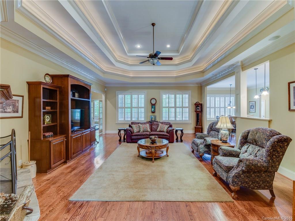 6706 Fox Ridge Circle Davidson, NC 28036 - Photo 5 of 24 a living room with furniture a flat screen tv and a chandelier