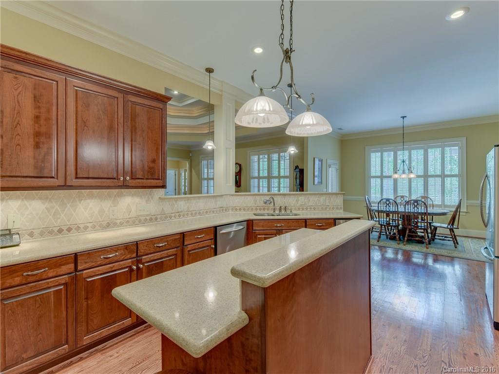 6706 Fox Ridge Circle Davidson, NC 28036 - Photo 8 of 24 a large kitchen with kitchen island a large island in the center a sink a window and stainless steel appliances