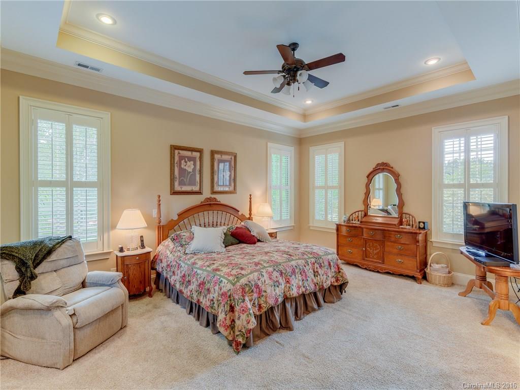 6706 Fox Ridge Circle Davidson, NC 28036 - Photo 10 of 24 a bedroom with a bed couches and a flat tv screen