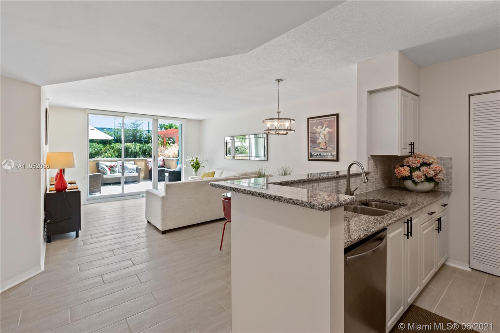 90 Alton Road, Unit 608 Miami Beach, FL 33139 - Photo 2 of 21 a living room with granite countertop kitchen island furniture and a fireplace