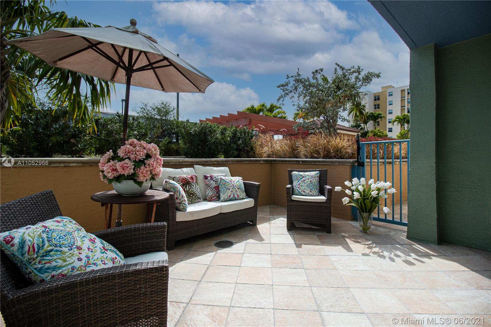 90 Alton Road, Unit 608 Miami Beach, FL 33139 - Photo 11 of 21 a outdoor living space with furniture and umbrella