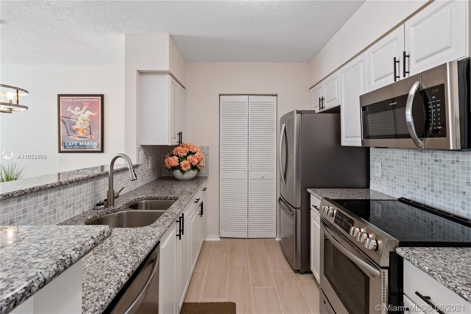 90 Alton Road, Unit 608 Miami Beach, FL 33139 - Photo 3 of 21 a kitchen with stainless steel appliances granite countertop a sink stove and refrigerator