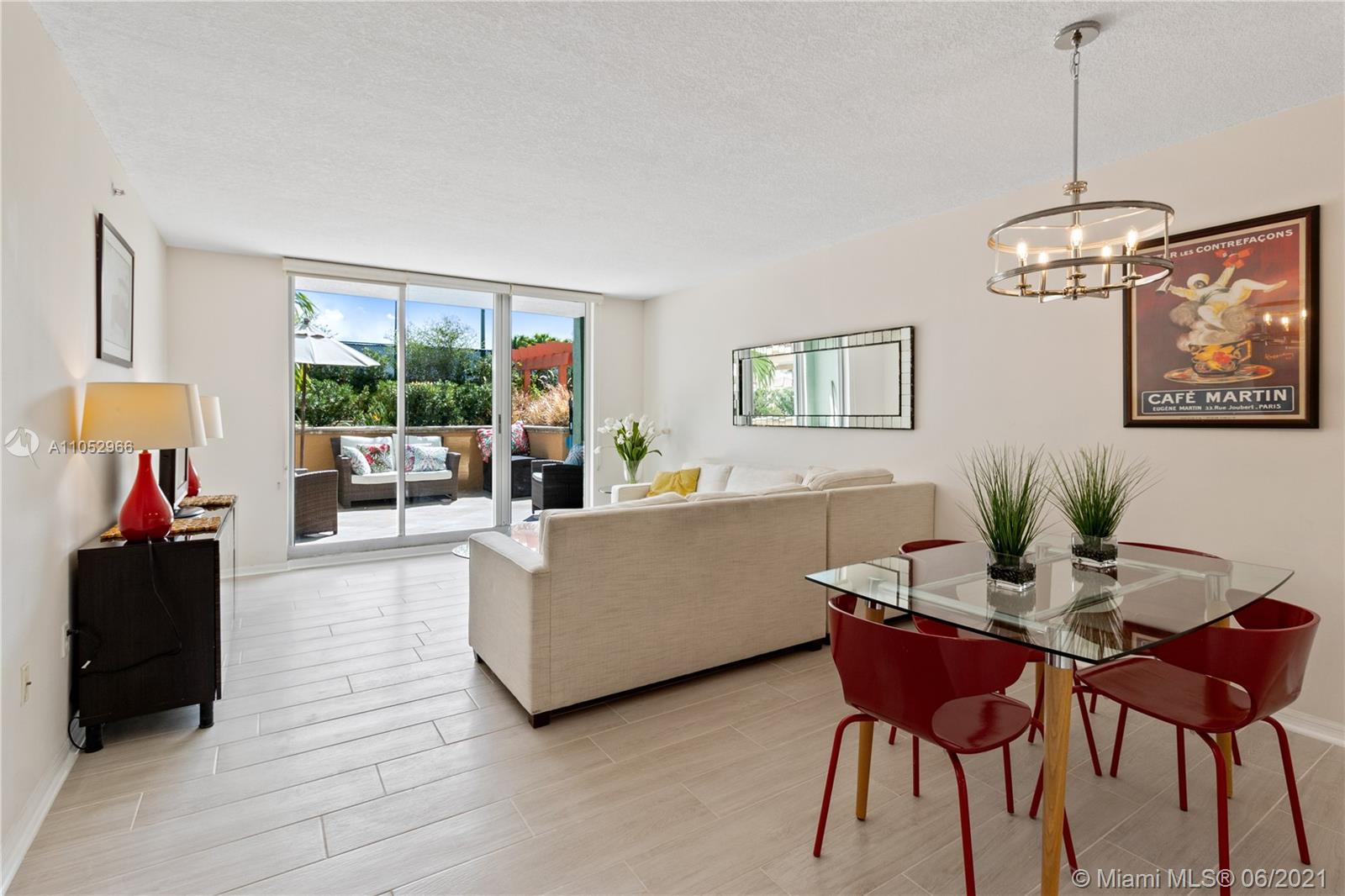 90 Alton Road, Unit 608 Miami Beach, FL 33139 - Photo 4 of 21 a living room with furniture and a chandelier