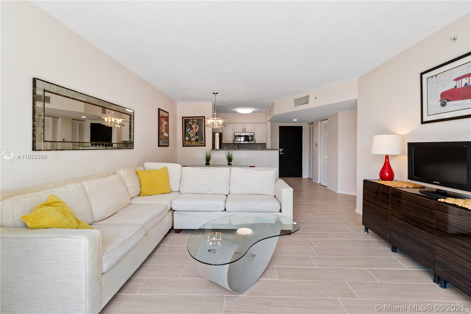90 Alton Road, Unit 608 Miami Beach, FL 33139 - Photo 5 of 21 a living room with furniture and a flat screen tv