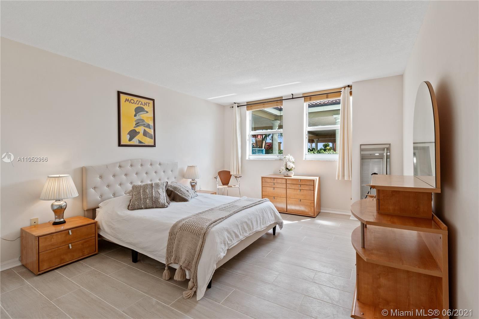 90 Alton Road, Unit 608 Miami Beach, FL 33139 - Photo 7 of 21 a bedroom with a bed and a couch