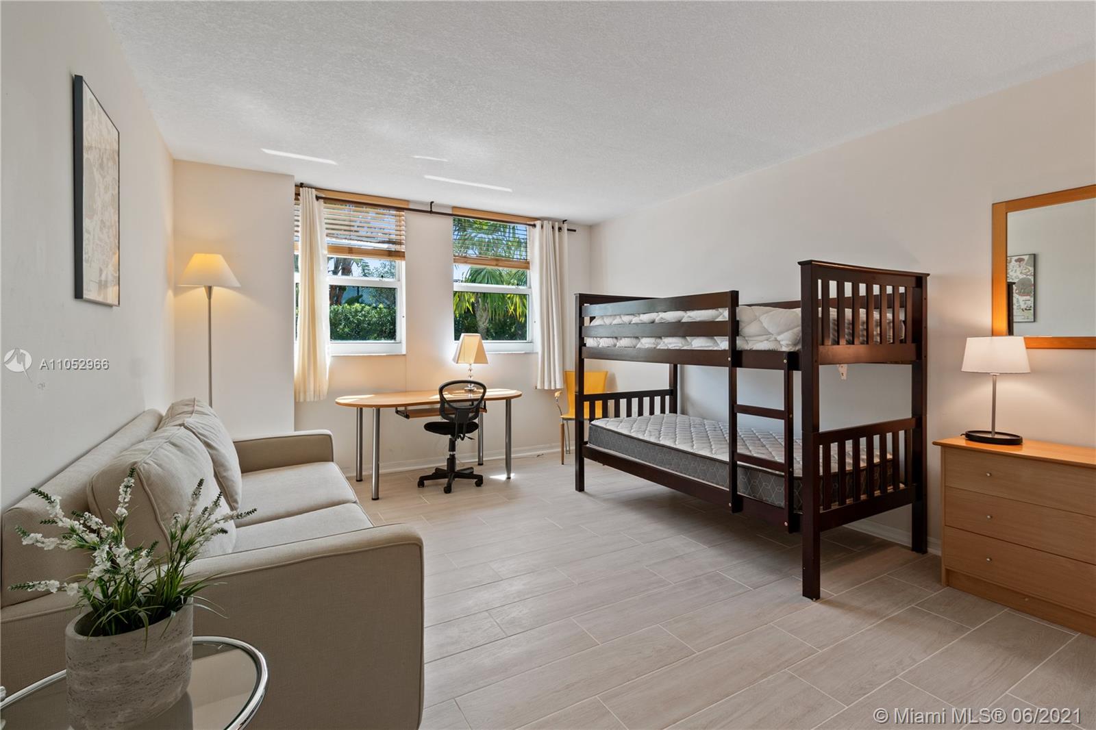 90 Alton Road, Unit 608 Miami Beach, FL 33139 - Photo 9 of 21 a bedroom with furniture and a potted plant