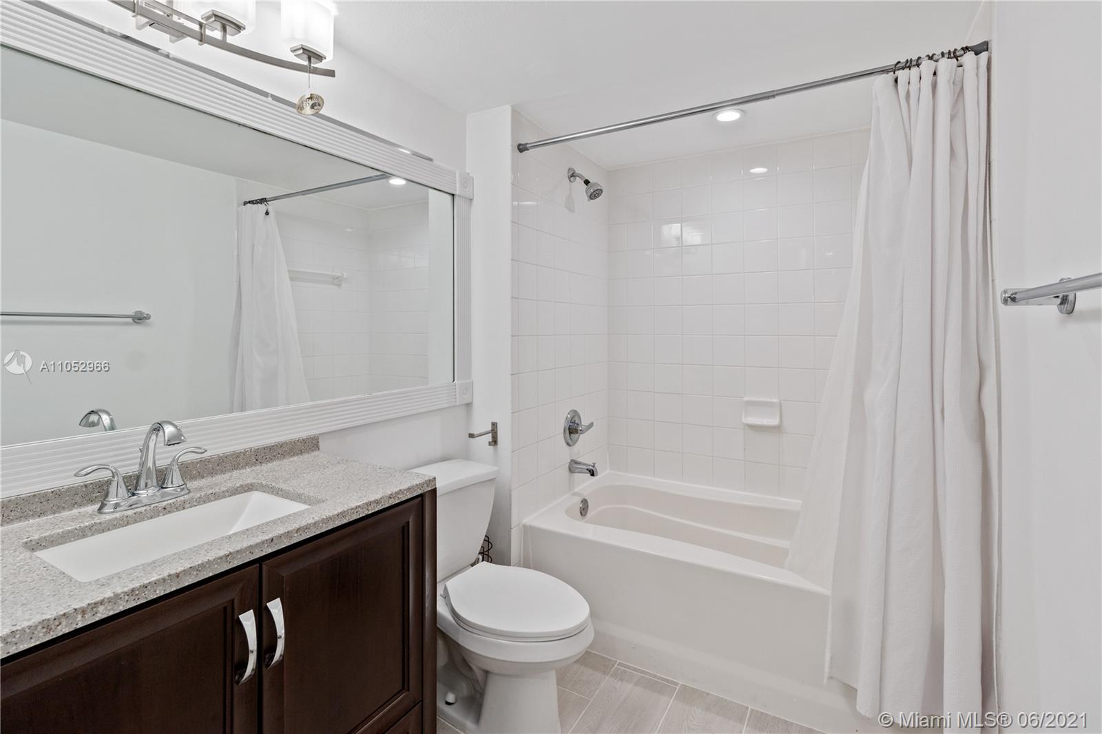 90 Alton Road, Unit 608 Miami Beach, FL 33139 - Photo 10 of 21 a bathroom with a granite countertop sink toilet and shower