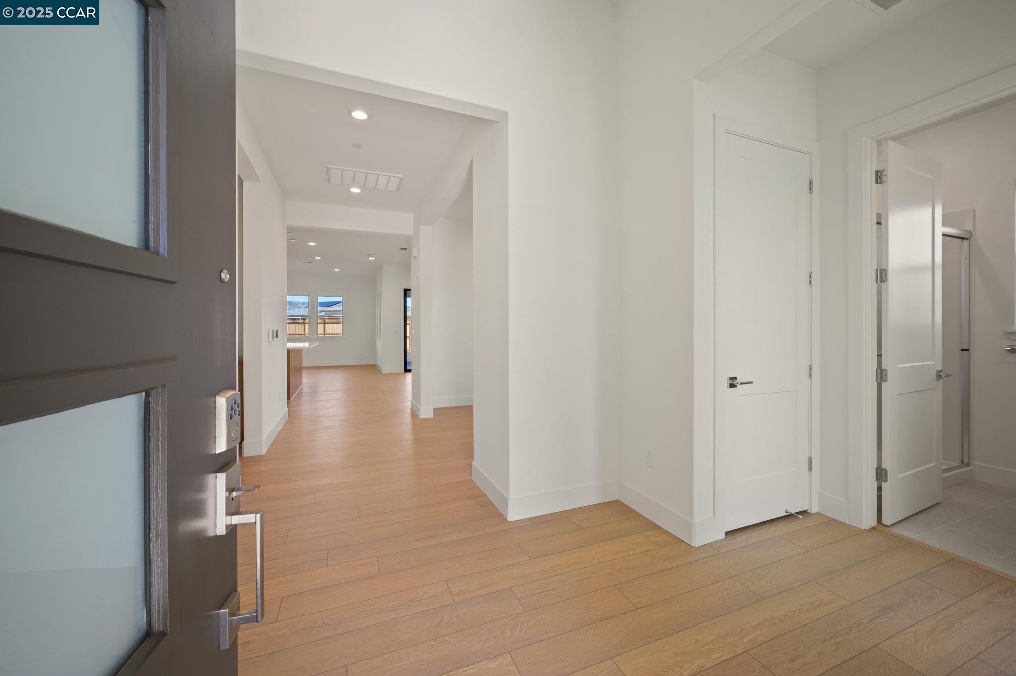 a view of a hallway with wooden floor