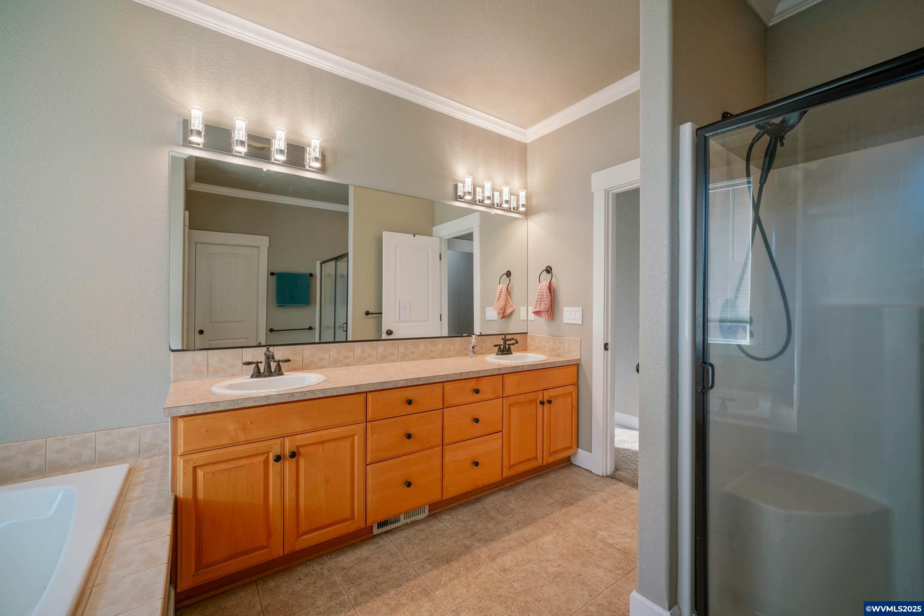 353 Northwest Reed Lane Dallas, OR 97338 - Photo 28 of 45 a bathroom with double vanity sinks and a mirror