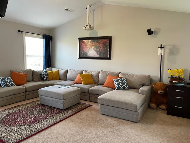 a living room with furniture a couch and a window