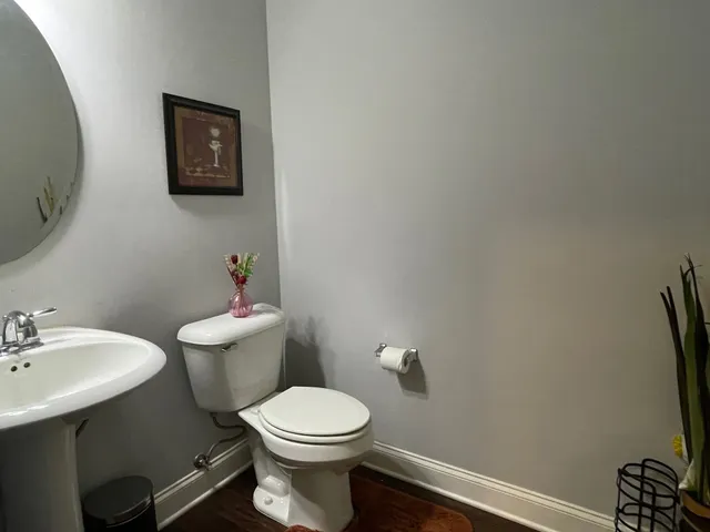 a bathroom with a toilet a sink and mirror