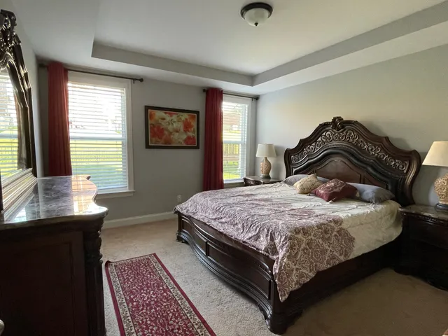 a bedroom with a bed and a table