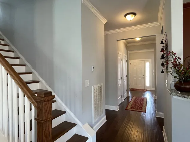 a view of entryway and hall with wooden floor