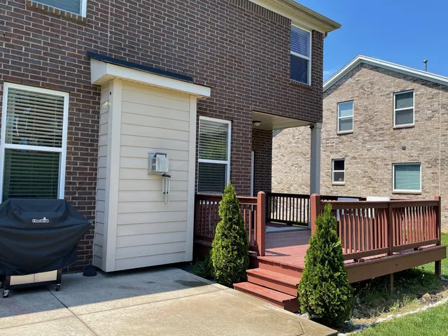 a view of a house with wooden fence