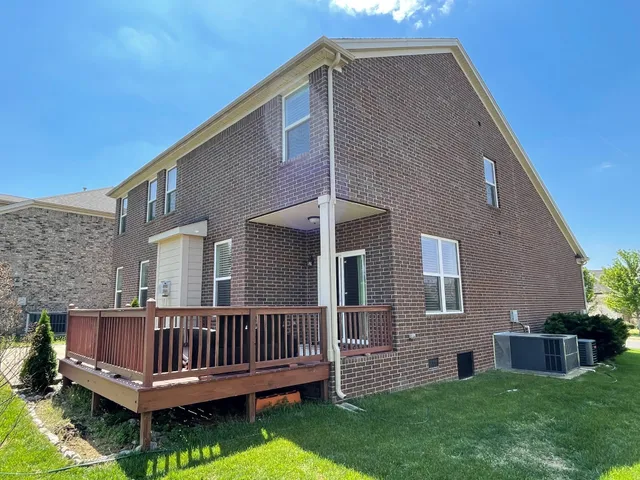 a view of a house with a yard and deck