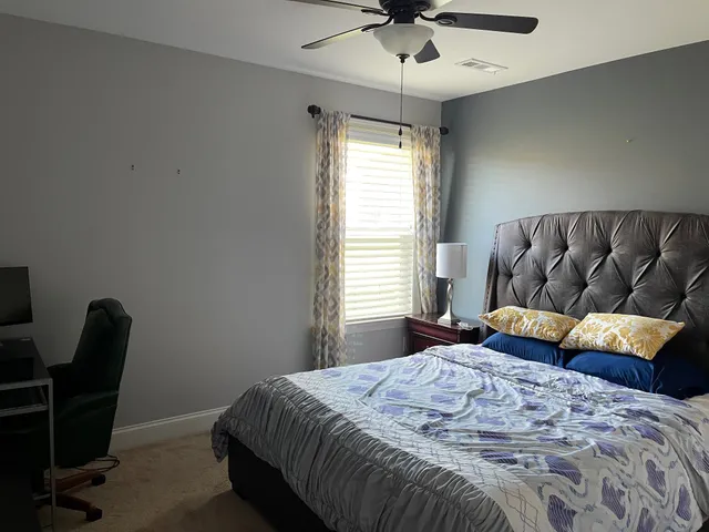 a bedroom with a bed and window