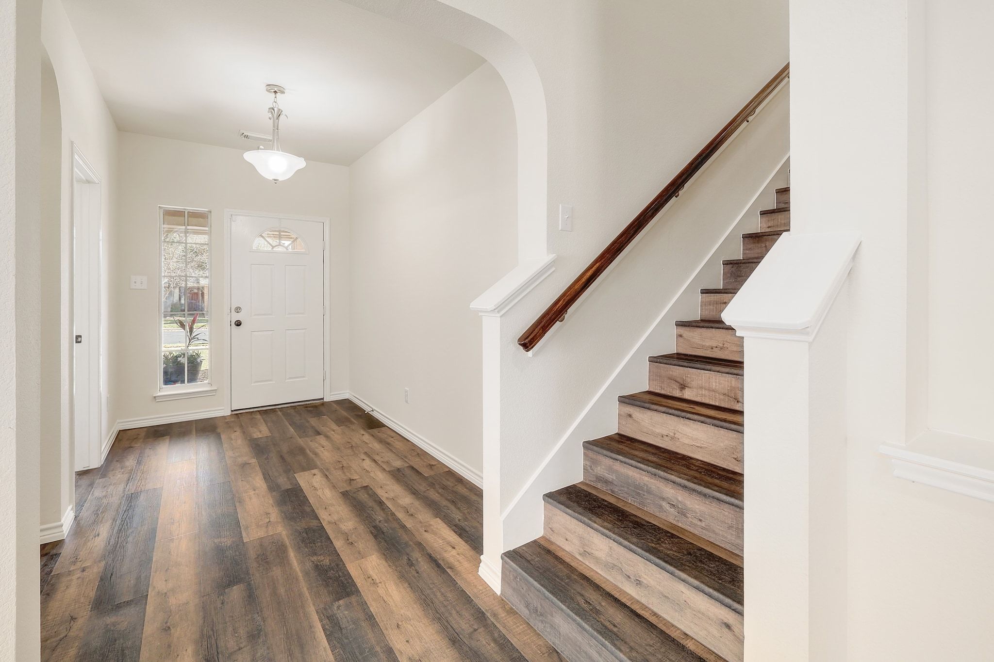 2307 Hayfield Square Pflugerville, TX 78660 - Photo 27 of 40 a view of a hallway with wooden floor and staircase