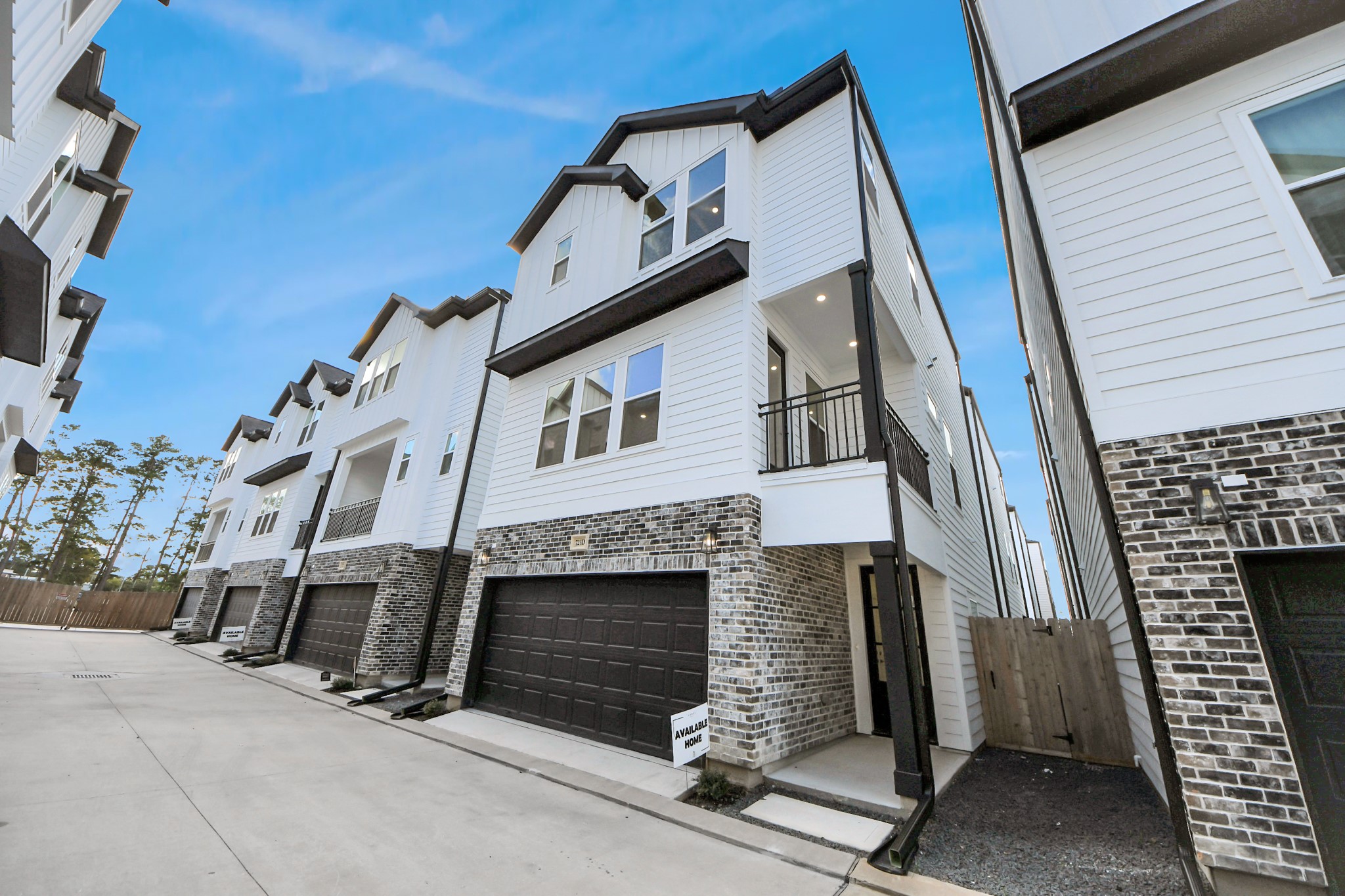 Modern 3 level home with a sleek design, featuring a two-car garage and balcony. Located in a neat, well-maintained community setting.