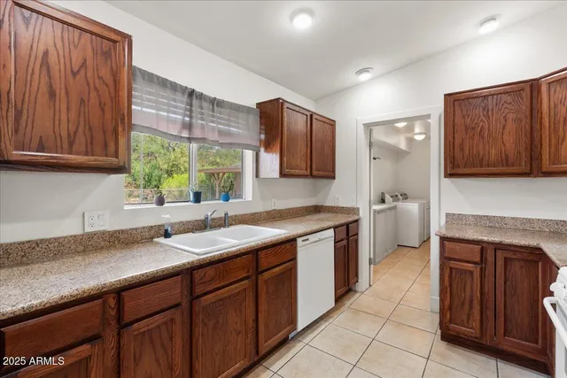 a kitchen with a sink cabinets and window