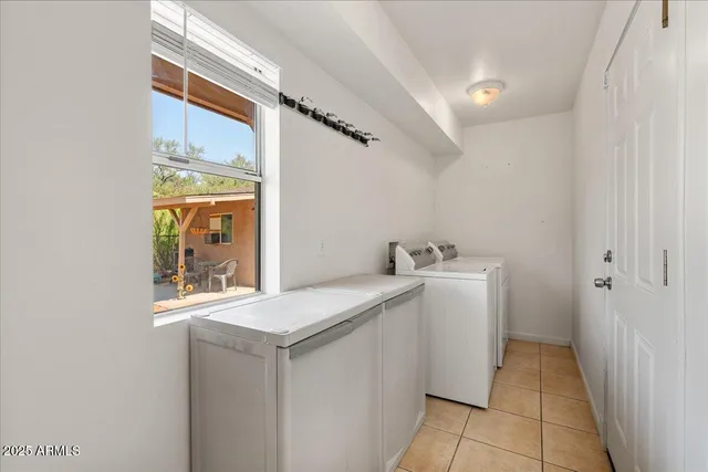 a utility room with a sink dryer and washer