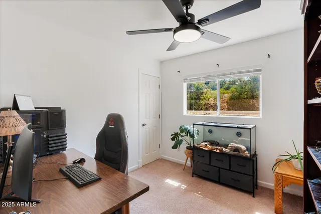 a livingroom with workspace and a window