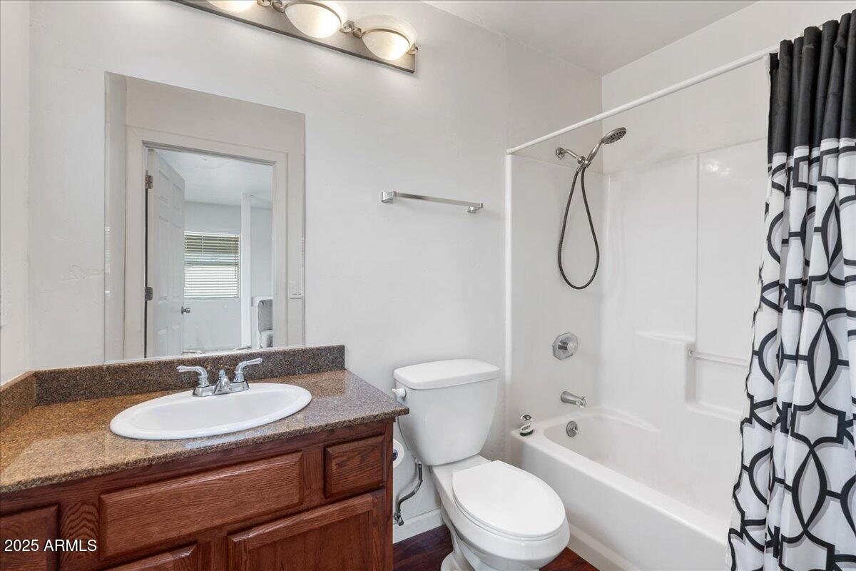 2527 Rio Verde Drive Cottonwood, AZ 86326 - Photo 24 of 43 a bathroom with a granite countertop sink toilet a mirror and shower